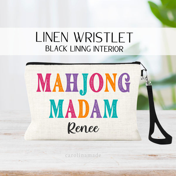 This linen zipper pouch features colorful text that says Mahjong Madam. It is personalized with your name at the bottom. Perfect for your mahjong group and game night!