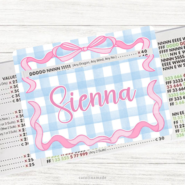 This acrylic mahjong line reader features a gingham background with a bow border. It is personalized in the center with your name.