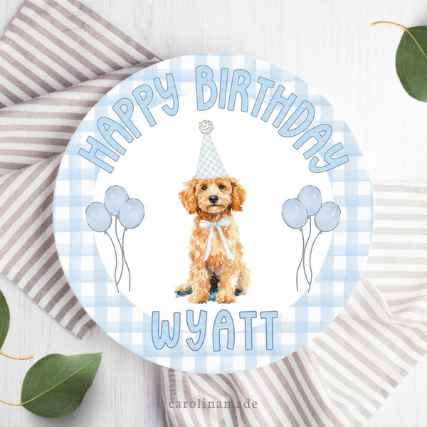 This 10 inch plate features a blue gingham background with a cream golden doddle  wearing a birthday hat and balloons in the center. The top says happy birthday and the bottom is personalized with your childs name.