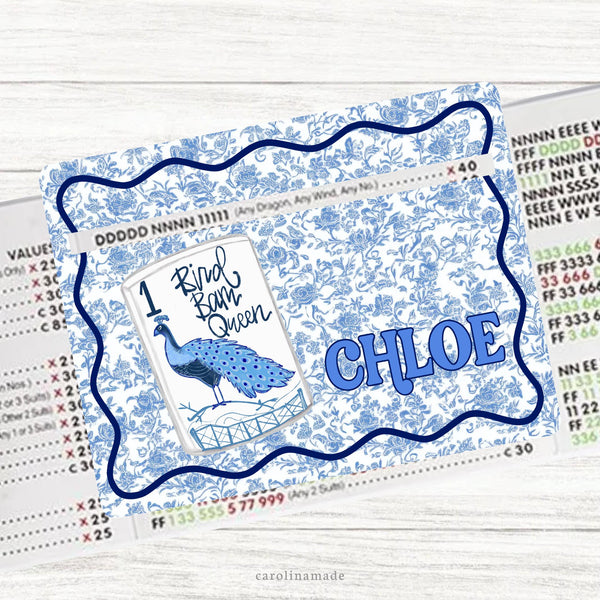 This acrylic mahjong line reader features a white and blue toile background with one big tile that says Bird Bam Queen with a large peacock on it. Your name is personalized next to the tile. Several zipper pouches available also.