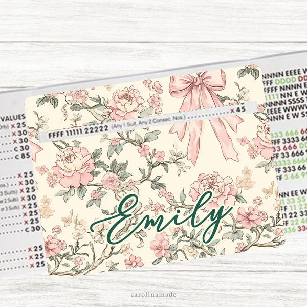 This acrylic mahjong line reader features a cream background with a vintage coquette design with leaves and roses and pink bow. The bottom is personalization with your name. Several zipper pouchs available also.