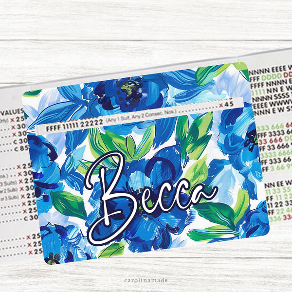 This acrylic mahjong line reader features a floral background with big blue watercolor flowers and green leaves. The bottom is personalization with your name. Several mahj zipper pouches available also.