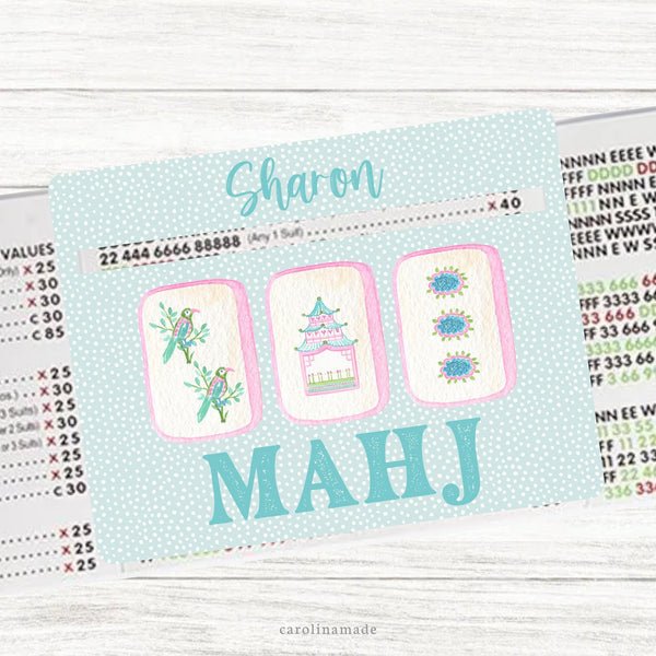 This acrylic mahjong line reader features a teal background with three colorful mahjong tiles and your name personalized at the top. Matching zipper pouch available also.