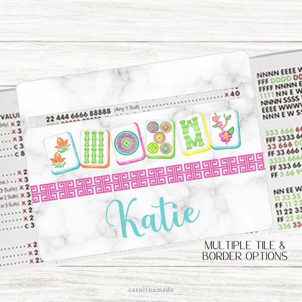 This acrylic mahjong line reader features a marble background with 6 colorful mahjong tiles with a Chinese border and your name personalized at the bottom. Choose from multiple tile set options. Matching zipper pouch available also.