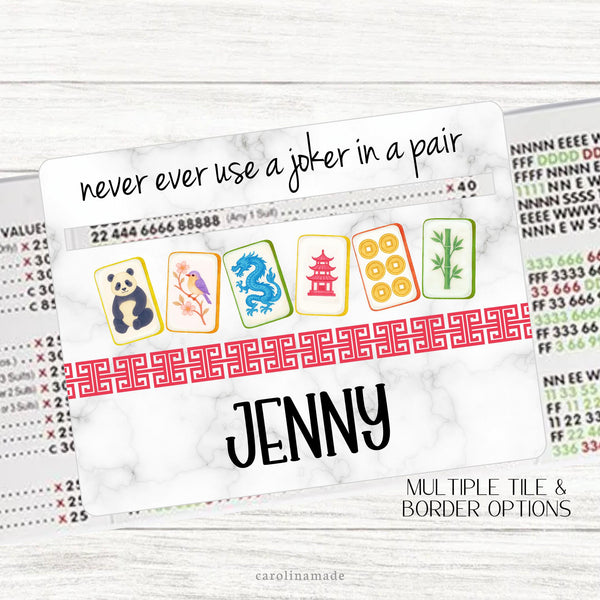 This acrylic mahjong line reader features a marble background with 6 colorful mahjong tiles with a Chinese border and your name personalized at the bottom. The top says never ever use a joker in a pair. Choose from multiple tile set options. Matching zipper pouch available also.