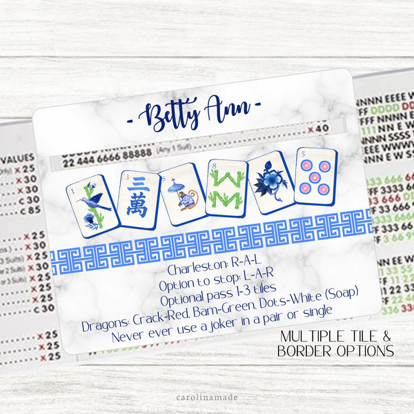 This acrylic mahjong line reader features a marble background with 6 colorful mahjong tiles with a Chinese border and your name personalized at the top. The bottom features a Mahjong Rules helper perfect for beginners.  Choose from multiple tile set options. Matching zipper pouch available also.