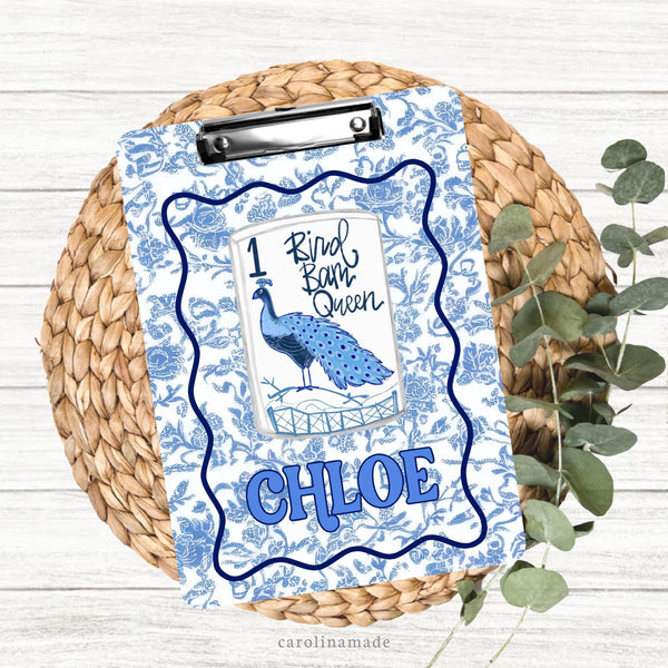 This colorful double sided clipboard features a blue and white floral toile background with navy wavy border. The center features a mahjong tile that says bird bam queen and is personalized on the bottom with your name.
