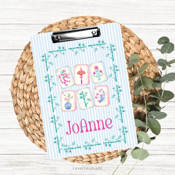 This colorful double sided clipboard features a blue and white stripped background with a bamboo border. The center features says 6 mahjong tiles and is personalized on the bottom with your name.