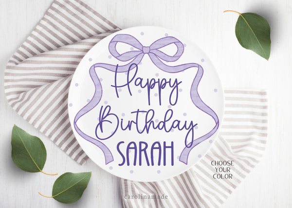 This ten inch plate features a purple poka dot plate with a long ribbon bow around the plate. It is personalized with your childs name.