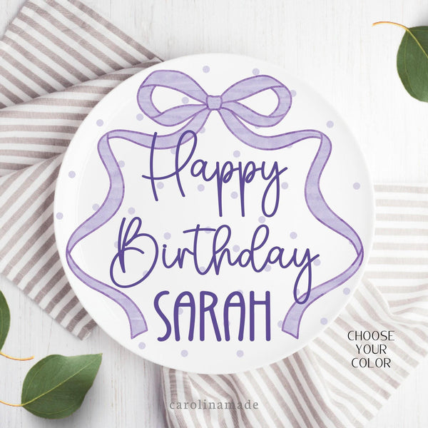 This ten inch plate features a purple poka dot plate with a long ribbon bow around the plate. It is personalized with your childs name.