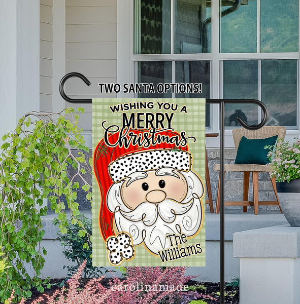 Wishing You a Merry Christmas porch flag! Green plaid background with large Santa in the center. Flag is personalized on the bottom corner with your name.